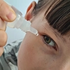 Applying eye drops for treatment